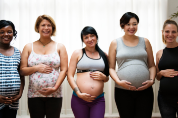 A line of pregnant people showing their bellies