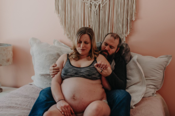 Partner supporting a pregnant person during a contraction.